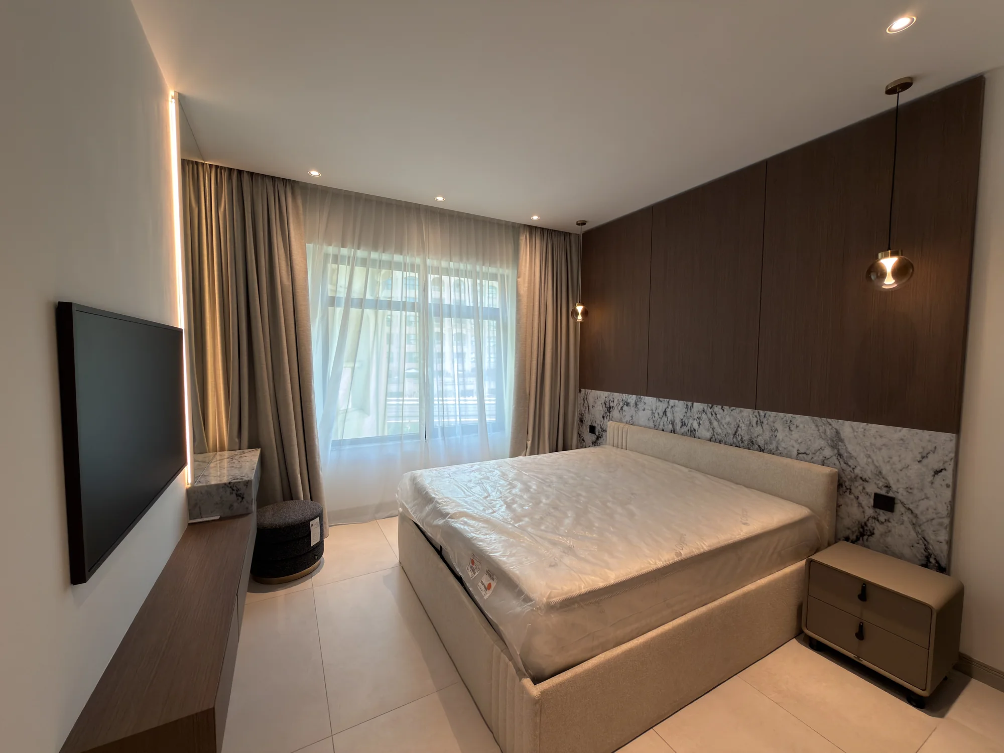 Bedroom interior with cove and pendant lighting at the Shoreline residence